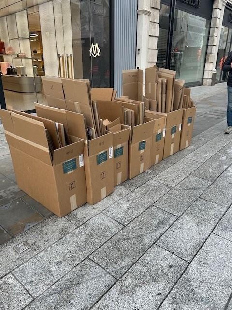 Tagged cardboard waste staged for kerbside collection on Bond Street